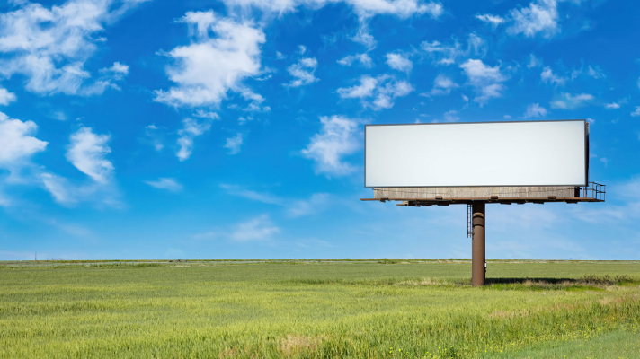 Image of fields with a blank billboard